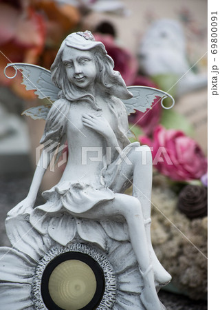 Closeup of stoned elf on tomb in a cemetery 69800091