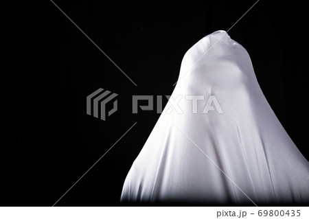 frightening ghost in a white sheet nightmare on black background 69800435