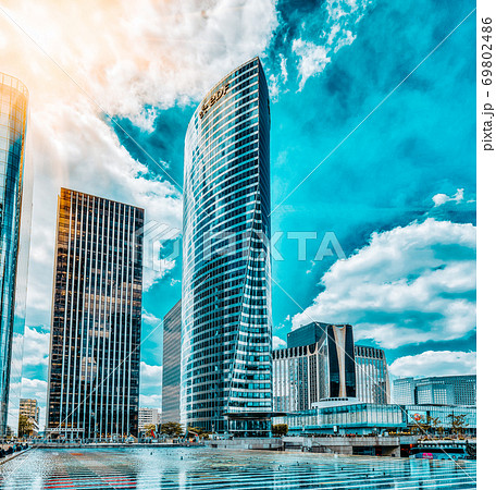 PARIS, FRANCE - JULY 06, 2016 :La Defense, Business Quarter with businessmen in the streets, area of Paris, French financial center with skyscrapers and modern buildings. PARIS, FRANCE - JULY 06, 2016 :La Defense, Business Quarter with businessmen in the streets, area of Paris, French financial center with skyscrapers and modern buildings. 69802486