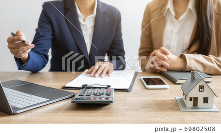 House model with agent and customer discussing for contract to buy, get insurance or loan estate. 69802508