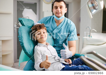 Happy dentist and child raised their thumb Happy dentist and child raised their thumb 69802866