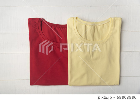 Yellow and red cotton blank t-shirt on white background. Mockup 69803986