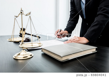 Professional women lawyers work at a law office There are scales, Scales of justice, judges gavel, and litigation documents. Concepts of law and justice 69804041