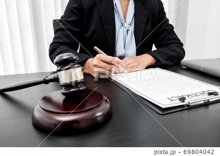 Professional women lawyers work at a law office There are scales, Scales of justice, judges gavel, and litigation documents. Concepts of law and justice 69804042