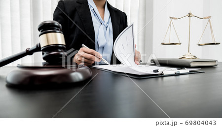 Professional women lawyers work at a law office There are scales, Scales of justice, judges gavel, and litigation documents. Concepts of law and justice 69804043