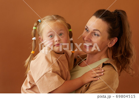 Mother Holding Girl with Down Syndrome in Studio 69804515