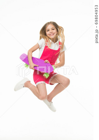 Happy child jump with penny board isolated on white.  69804953