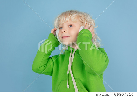 Portrait of beautiful caucasian little boy isolated on blue studio background 69807510