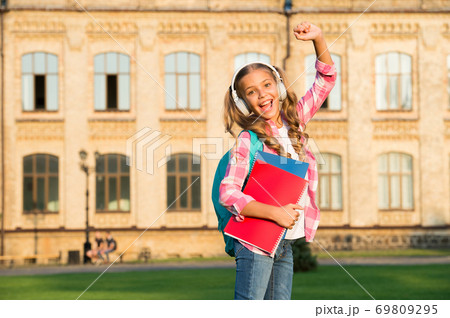 small girl with book and headset. literature for kids 69809295