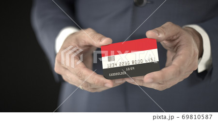 Businessman holds plastic bank card with printed flag of Yemen in his hands, fictional numbers 69810587