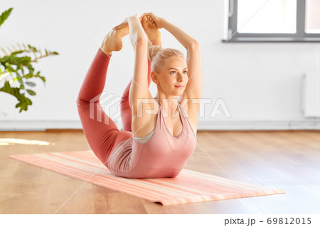 woman doing bow pose at home or yoga studio woman doing bow pose at home or yoga studio 69812015