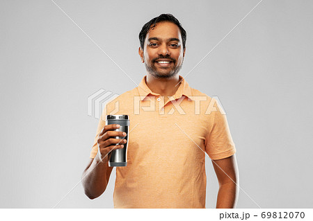 indian man with thermo cup or tumbler for drink indian man with thermo cup or tumbler for drink 69812070