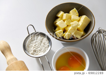 rolling pin, butter, eggs, flour and whisk rolling pin, butter, eggs, flour and whisk 69812289