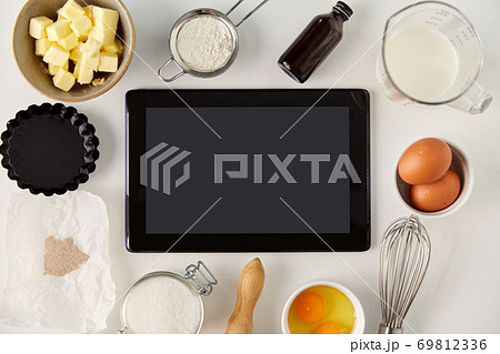 tablet computer and cooking ingredients on table tablet computer and cooking ingredients on table 69812336