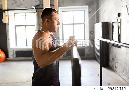 young man at parallel bars in gym 69812556