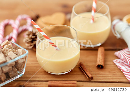 glasses of eggnog, ingredients and spices on wood 69812729