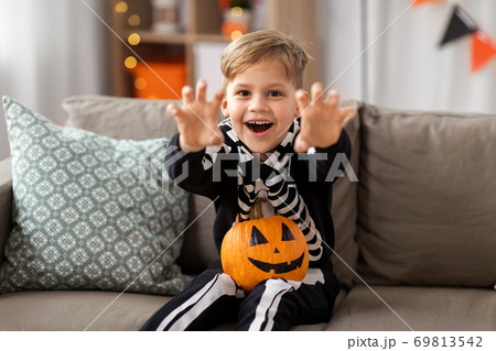 happy boy in halloween costume of skeleton at home happy boy in halloween costume of skeleton at home 69813542