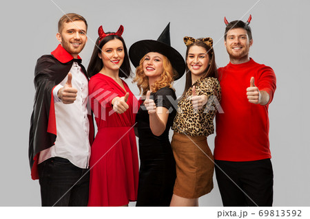 happy friends in halloween costumes snow thumbs up happy friends in halloween costumes snow thumbs up 69813592
