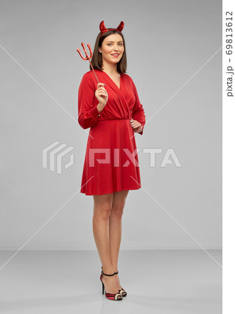 happy woman in red halloween costume of devil 69813612