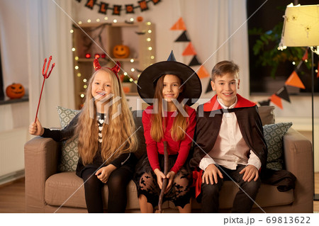 kids in halloween costumes at home at night 69813622