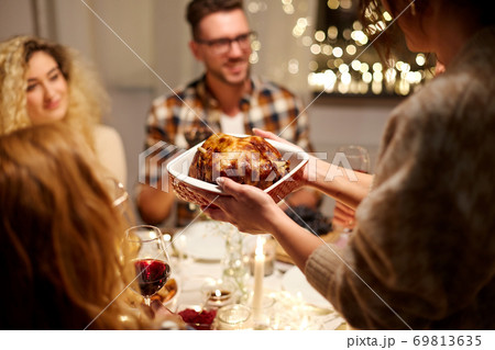 happy friends having christmas dinner at home 69813635