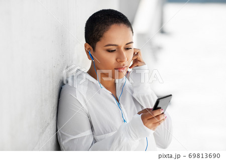 african american woman with earphones and phone african american woman with earphones and phone 69813690