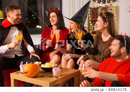happy friends in halloween costumes at home party happy friends in halloween costumes at home party 69814178
