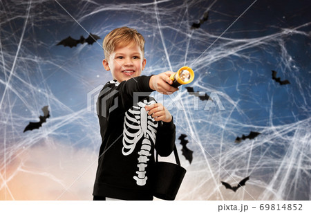 boy with candies and flashlight on halloween boy with candies and flashlight on halloween 69814852