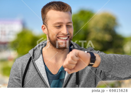 happy man with fitness tracker in city happy man with fitness tracker in city 69815628