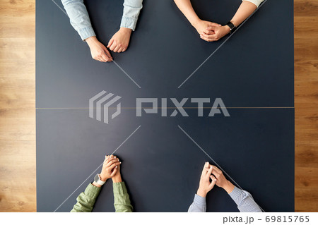 business team sitting at office table 69815765
