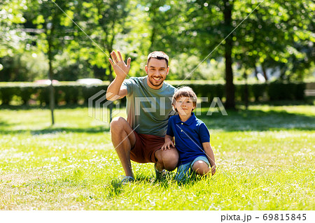 happy smiling father and little son at summer park happy smiling father and little son at summer park 69815845