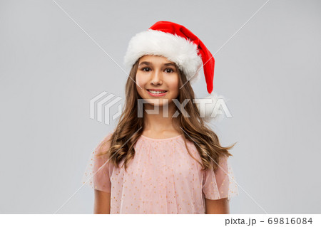 happy teenage girl in santa hat on christmas 69816084