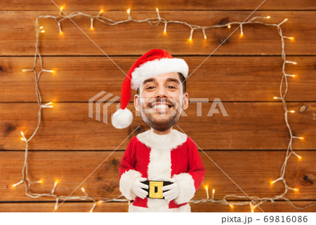 happy santa over garland on wooden background 69816086