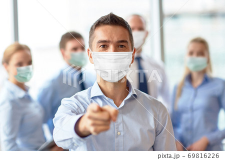 businessman in mask pointing finger at office businessman in mask pointing finger at office 69816226