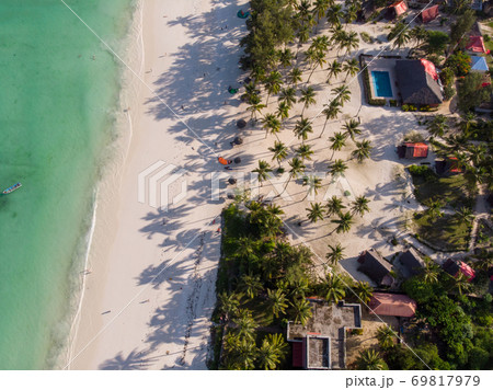 Aerial shot of a luxury hotel on a Beach first line with Palm Trees Garden at evening time in Paje village, Zanzibar, Tanzania 69817979