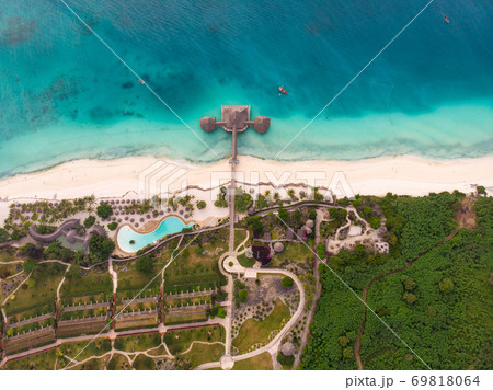 Top View on Beautiful thatch stilt house restaurant and Resort at Zanzibar Kendwa beach at evening time in Turquoise Water of Indian ocean 69818064