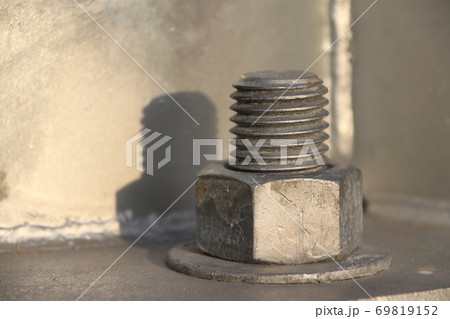 Big Screw and nut on metal background. Big Screw and nut on metal background. 69819152