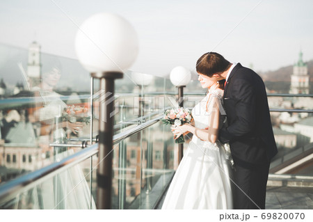 Gorgeous wedding couple walking in the old city of Lviv 69820070