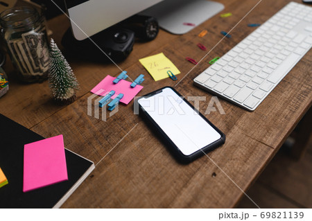 Smartphones on the desk and green devices, smart phone mockups 69821139