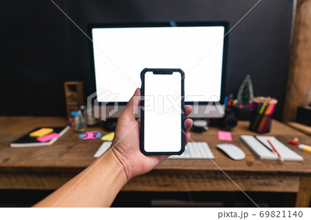 Smartphones on the desk and green devices, smart phone mockups 69821140