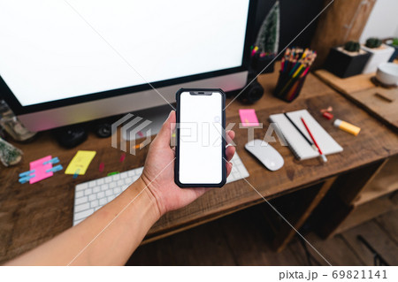 Smartphones on the desk and green devices, smart phone mockups Smartphones on the desk and green devices, smart phone mockups 69821141