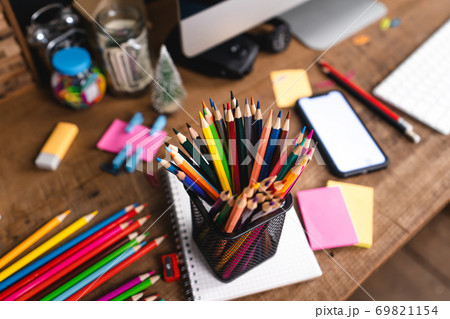 Desk Stationery on the desk, colored books and toys. 69821154