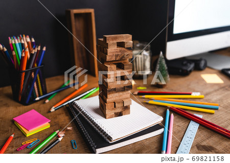 Desk Stationery on the desk, colored books and toys. 69821158