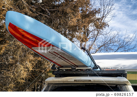 Unlimited racing stand up paddleboard on roof racks 69826157