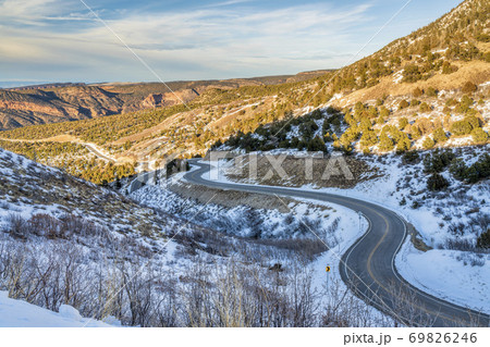 scenic windy mountain road in winter scenery 69826246