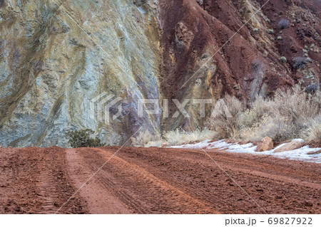 muddy canyon dirt road with rocky cliffs muddy canyon dirt road with rocky cliffs 69827922