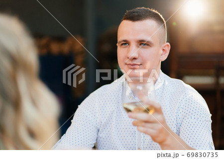 man. romantic dinner. lovers drink wine. man. romantic dinner. lovers drink wine. 69830735