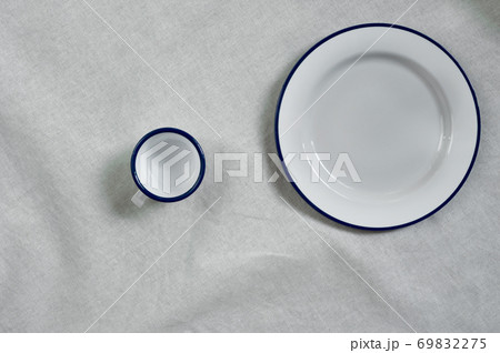 white blue dish and cup for food and drink on cotton fabric background white blue dish and cup for food and drink on cotton fabric background 69832275