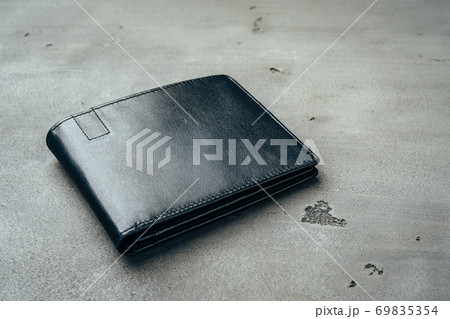 Black leather wallet on grey concrete background Black leather wallet on grey concrete background 69835354
