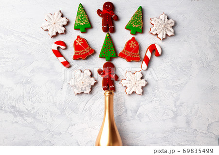 Golden champagne bottle with Christmas gingerbread flatlay Golden champagne bottle with Christmas gingerbread flatlay 69835499